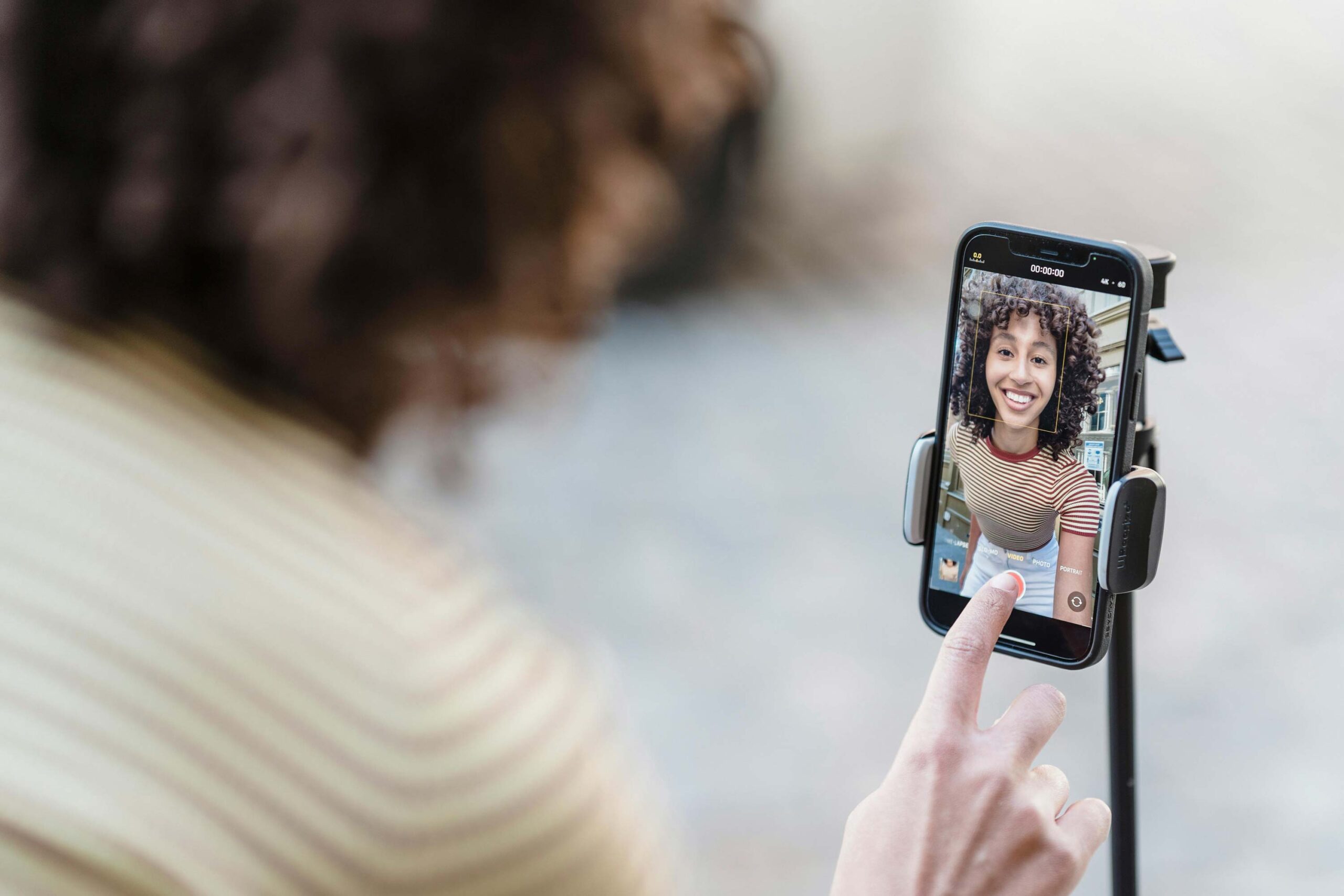 A woman live streaming on her phone.